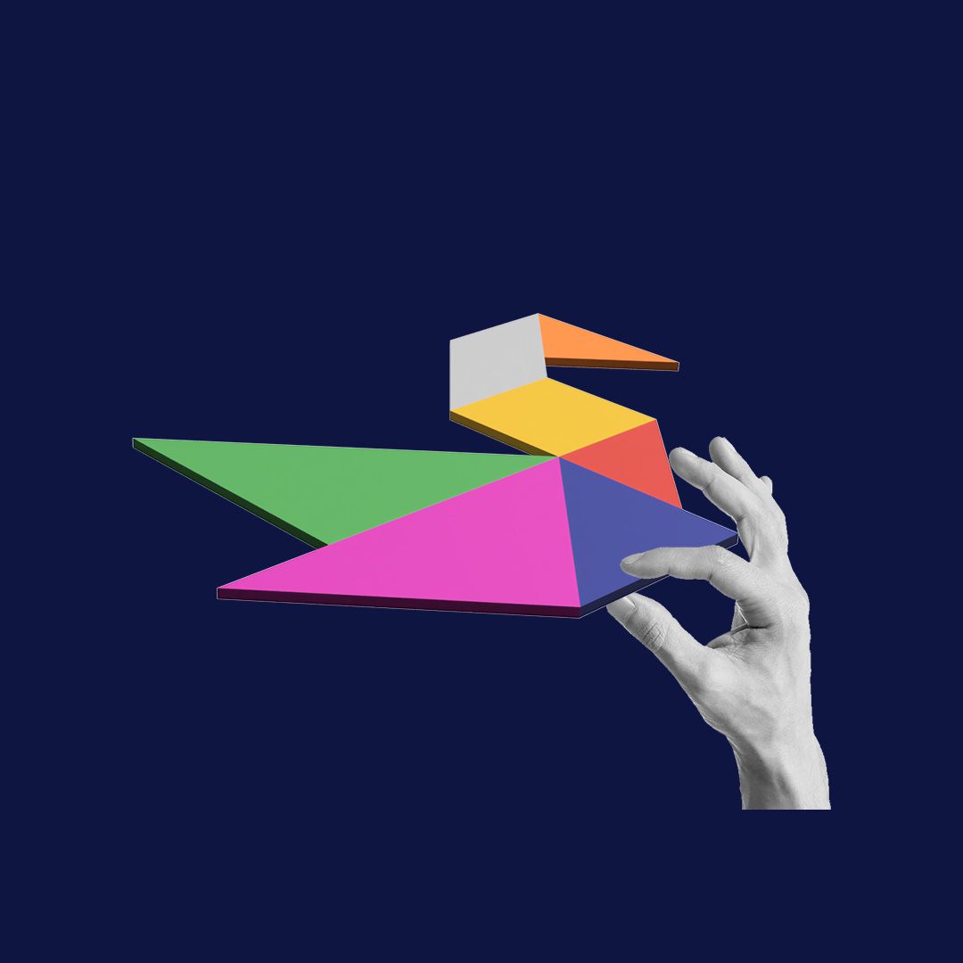Hand holding a multi-coloured tactile tangram puzzle.