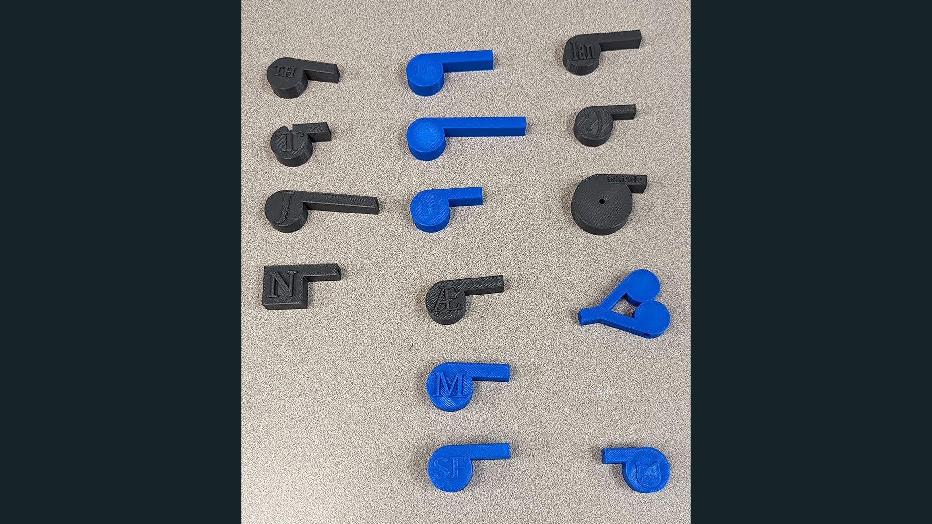 15 3D printed whistles, all varying in design.